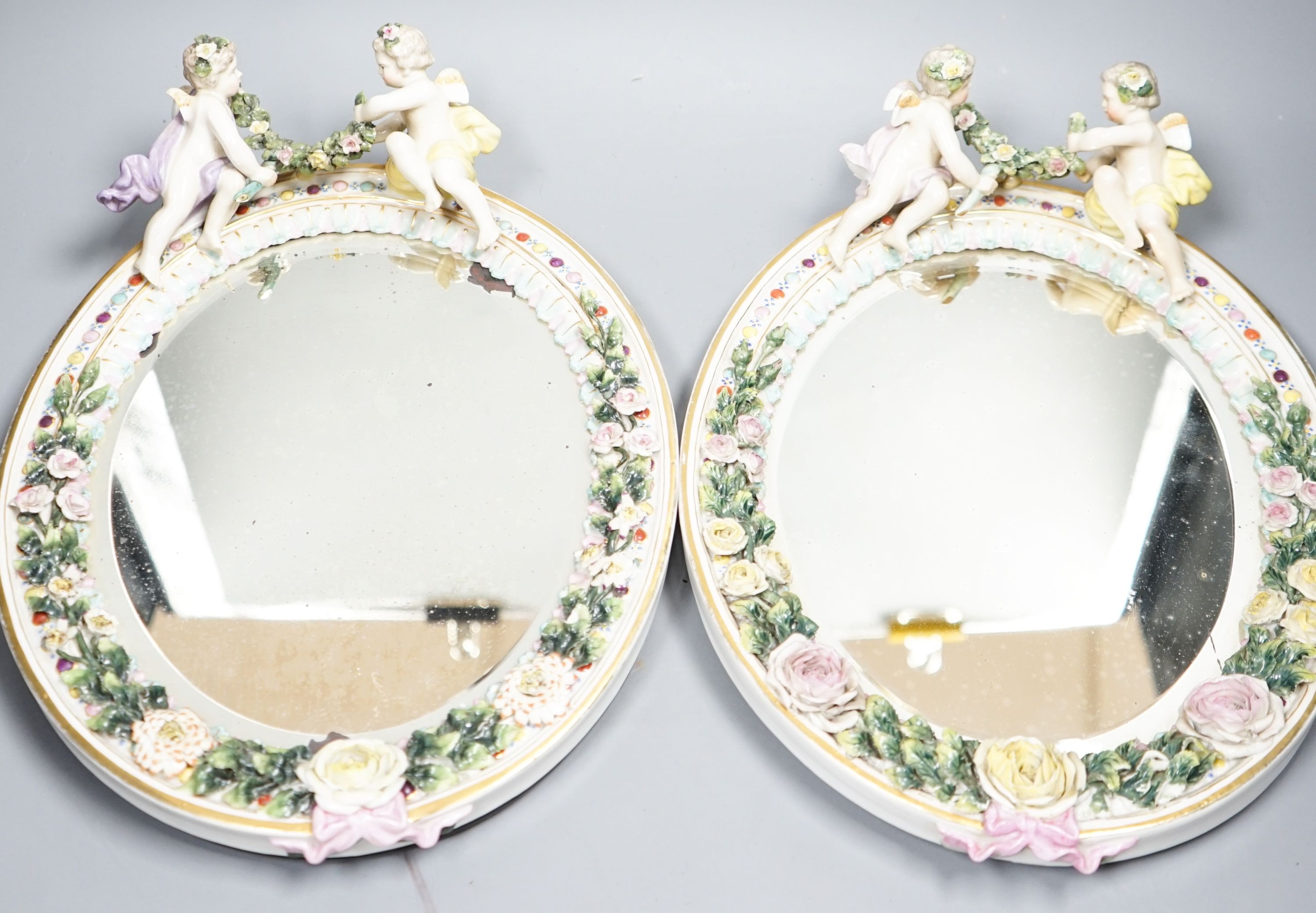 A pair of Sitzendorf oval mirror frames, 33cm